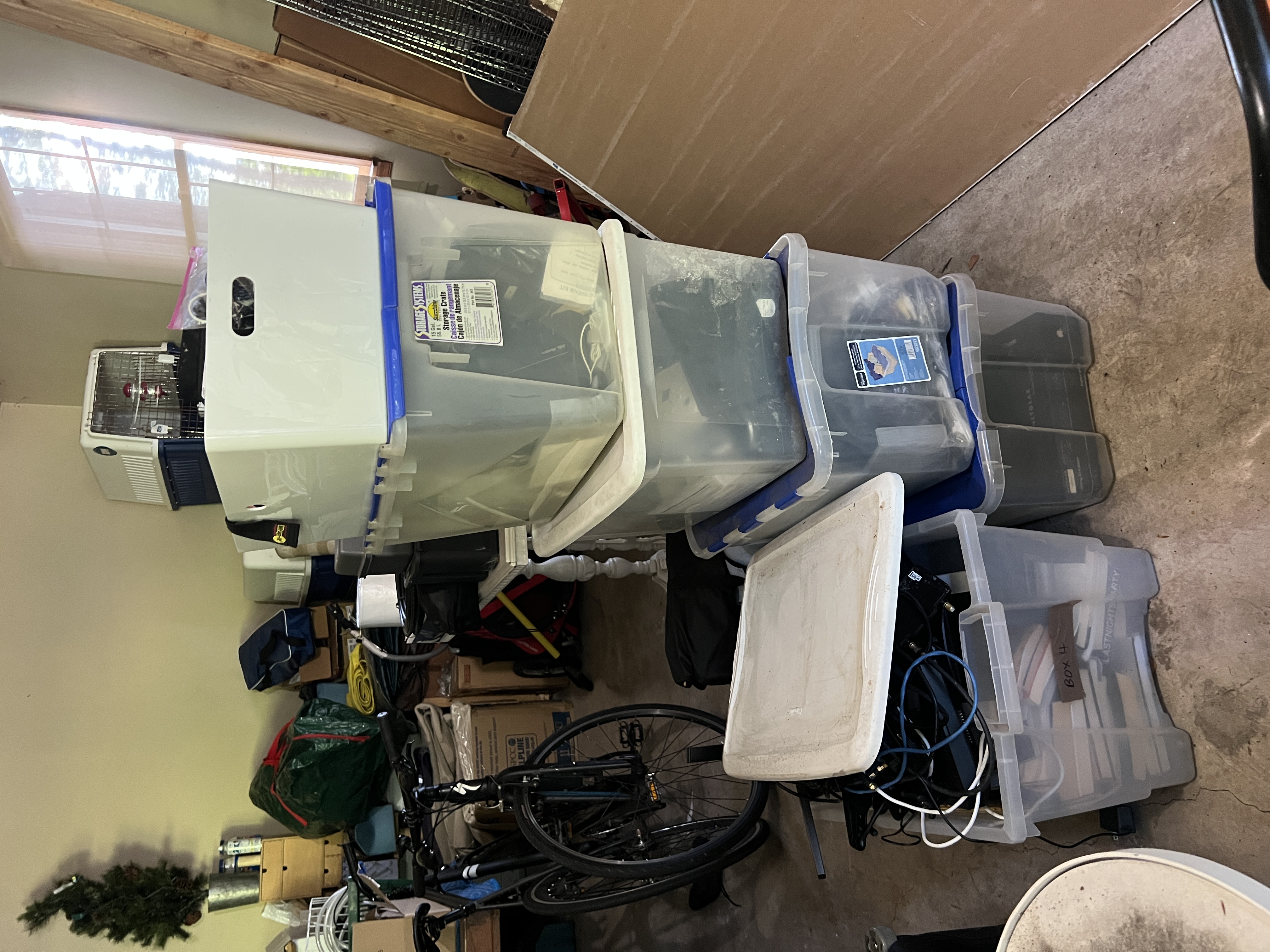 Storage bins and totes of e-waste staged in the New Hope garage, awaiting pickup assessment.