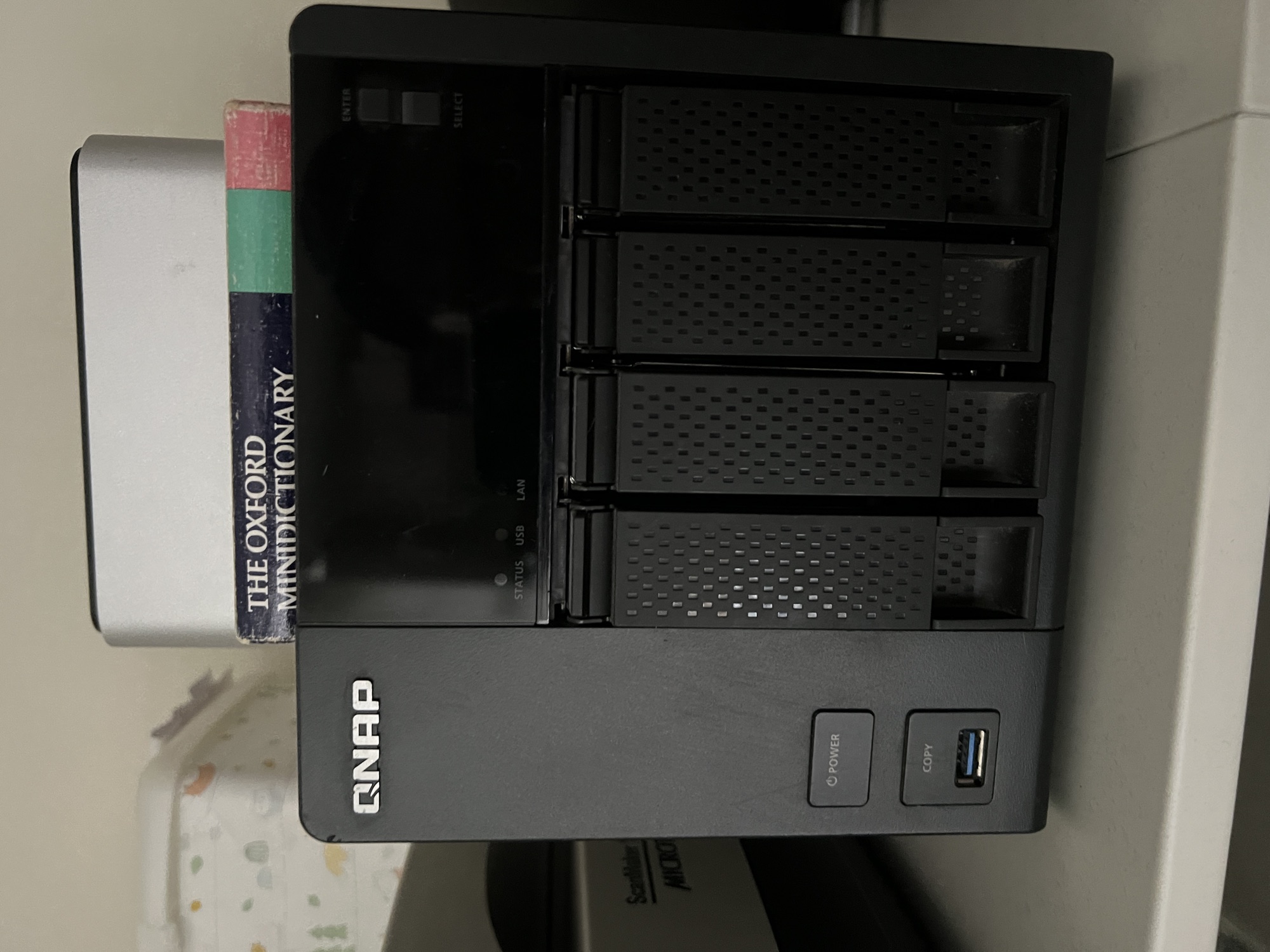 Front view of the QNAP TS-453A four-bay NAS — drive tray array with locking latches, STATUS / USB / LAN indicator LEDs, ENTER and SELECT navigation keys, the POWER button and front USB 3.0 COPY port visible at the foot of the enclosure.