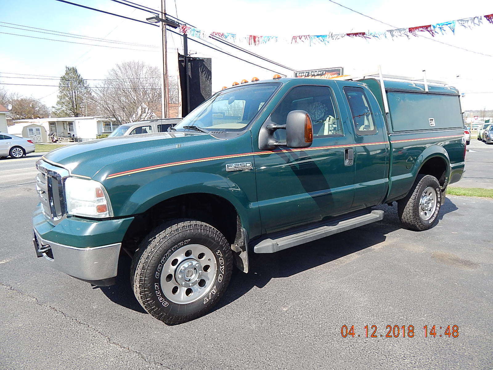 2018-04 eBay listing photo: F-250 front-quarter at the dealer lot, showing XLT badging, fender flares, Toyo Open Country A/T tires